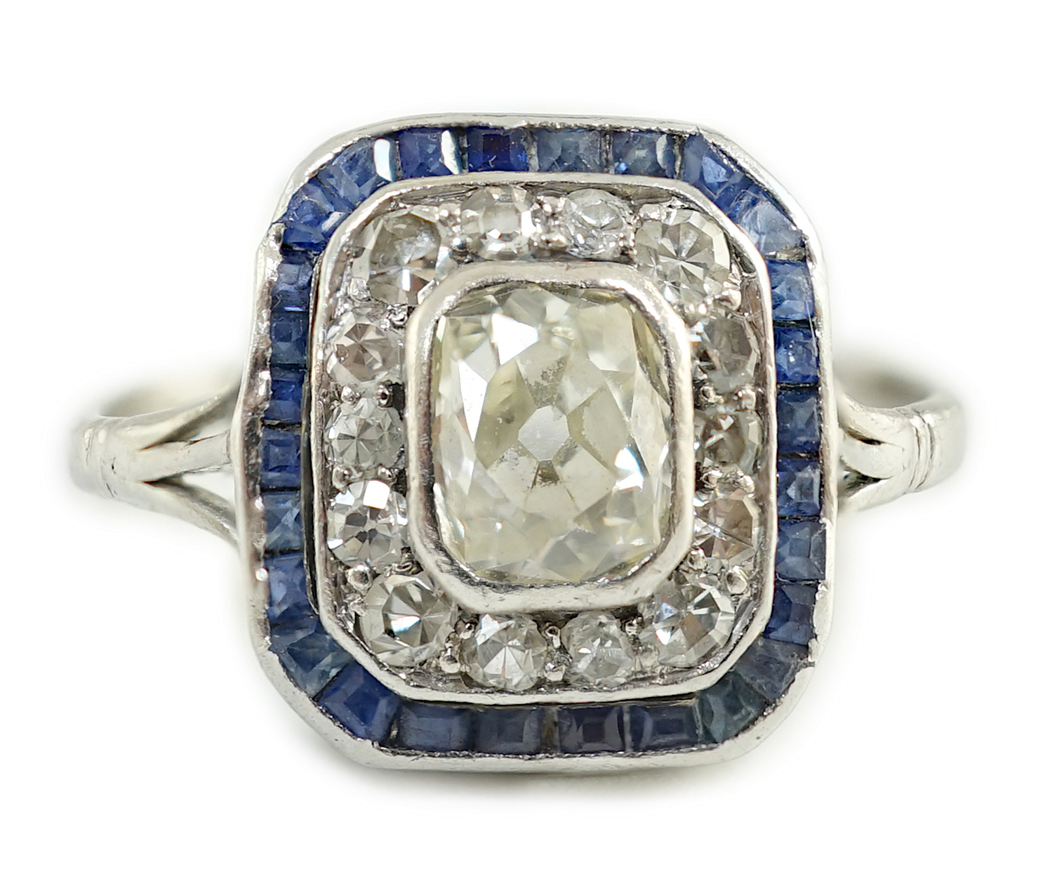 An Art Deco platinum, diamond and sapphire set rectangular cluster ring